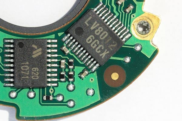 A printed circuit board (taken from a Canon digital camera), whose two exposed chips are manufactured using traditional methods.